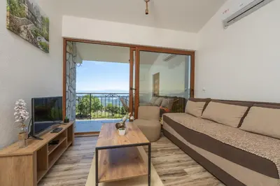 a living room with a couch and a table at Jasen Apartments Lakeview in Virpazar