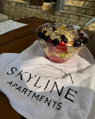 a bowl of fruit sitting on top of a table at Skyline Apartments in Dobra Voda