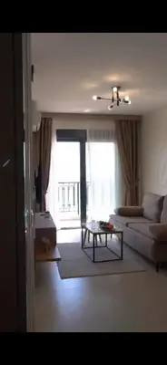 a living room with a couch and a table at Skyline Apartments in Dobra Voda