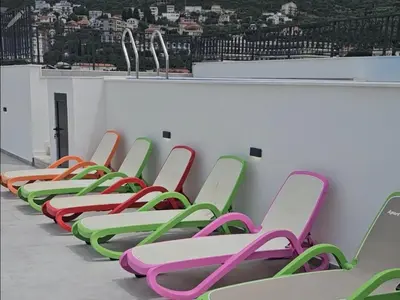 a row of chairs lined up on a roof at Skyline Apartments in Dobra Voda