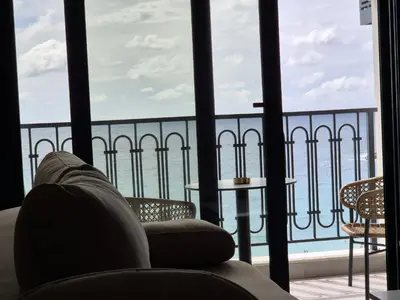 a room with a view of the ocean from a balcony at Skyline Apartments in Dobra Voda