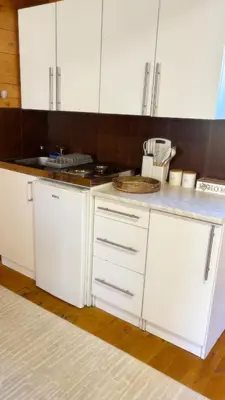 a kitchen with white cabinets and a counter top at Virpazar Oaza in Virpazar