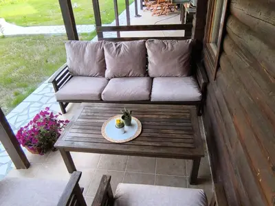 a couch and a plate on a table on a porch at Virpazar Oaza in Virpazar