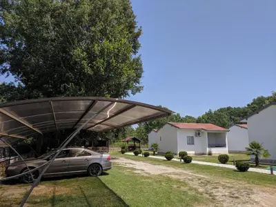 a car parked under a canopy in a yard at Beni Bungalows in Ulcinj