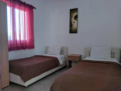 two beds sitting next to each other in a room at Beni Bungalows in Ulcinj