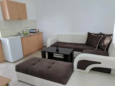 a small living room with a couch and a table at Beni Bungalows in Ulcinj