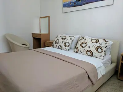 a bedroom with a white bed with pillows at Beni Bungalows in Ulcinj