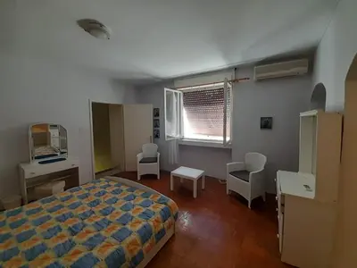 a bedroom with a bed and a desk and chairs at Beach edge 4-Bed House in Muo Kotor in Kotor