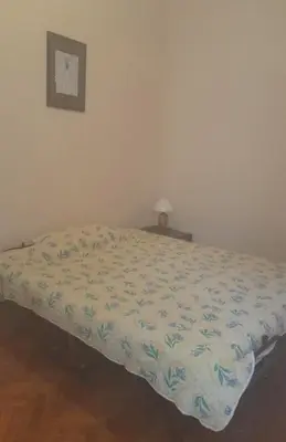 a bed with a comforter on it in a bedroom at Beach edge 4-Bed House in Muo Kotor in Kotor