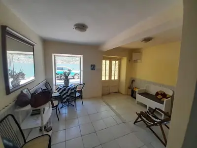 a living room with a table and chairs at Beach edge 4-Bed House in Muo Kotor in Kotor