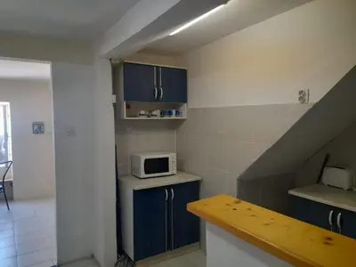 a small kitchen with blue cabinets and a microwave at Beach edge 4-Bed House in Muo Kotor in Kotor