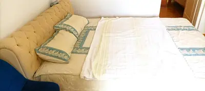 a bed with two pillows on top of it at 2-level apartment with terraces by the sea in Budva