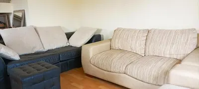a couch and a chair in a living room at 2-level apartment with terraces by the sea in Budva