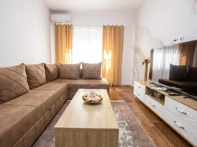a living room with a couch and a coffee table at Apartment Ochsen in Ulcinj