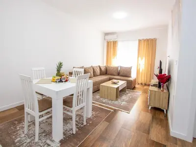 a living room with a white table and a couch at Apartment Ochsen in Ulcinj