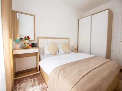 a bedroom with a large bed and a mirror at Apartment Ochsen in Ulcinj
