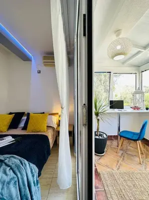 a bedroom with a bed and a desk in a room at Design studio in Petrovac in Petrovac na Moru