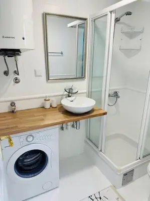a bathroom with a washing machine and a sink at Design studio in Petrovac in Petrovac na Moru
