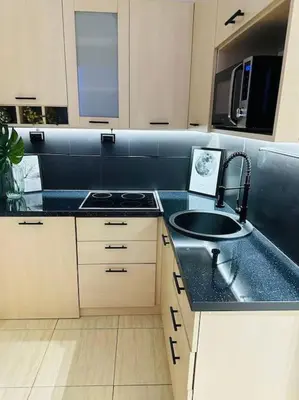 a kitchen with a sink and a counter top at Design studio in Petrovac in Petrovac na Moru