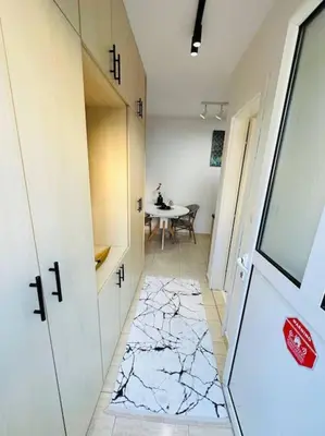 a hallway with a table and a room with a hallway at Design studio in Petrovac in Petrovac na Moru