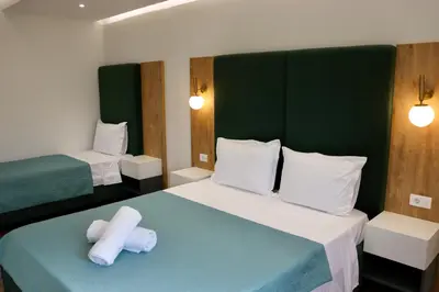 a hotel room with two beds with towels on it at Villa Cataleya in Ulcinj