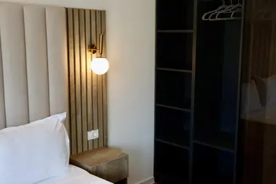 a bedroom with a bed and a light on a wall at Villa Cataleya in Ulcinj