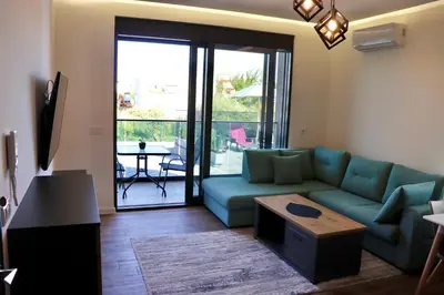 a living room with a blue couch and a table at Villa Cataleya in Ulcinj