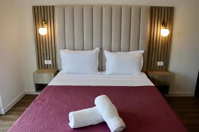 a hotel room with a bed with two towels on it at Villa Cataleya in Ulcinj