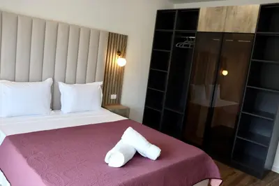a hotel room with a bed with a towel at Villa Cataleya in Ulcinj