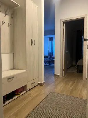 a living room with a large cabinet and a hallway at Apartman Tara in Ulcinj