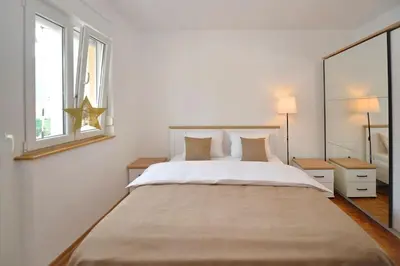 a white bedroom with a large bed and a window at Majestic Suite,800m to Old town&minutes to seaside in Kotor