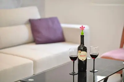 a bottle of wine and two glasses on a table at Majestic Suite,800m to Old town&minutes to seaside in Kotor