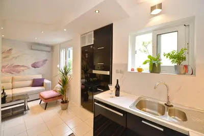 a kitchen with a sink and a living room at Majestic Suite,800m to Old town&minutes to seaside in Kotor