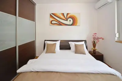 a bedroom with a large bed with white sheets at Majestic Suite,800m to Old town&minutes to seaside in Kotor