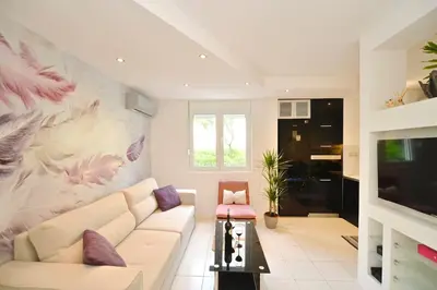 a living room with a white couch and a tv at Majestic Suite,800m to Old town&minutes to seaside in Kotor