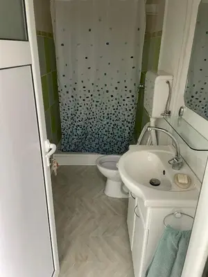 a bathroom with a sink and a toilet and a shower at Tobis hostel in Ulcinj