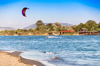 a person kite surfing in the water near a beach at Tobis hostel in Ulcinj