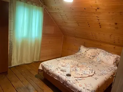 a bedroom with a bed with a wooden wall at Tobis hostel in Ulcinj