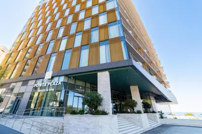 a tall building withwindows and stairs in front of it at Hotel Ponta Plaza Conference & Spa in Budva