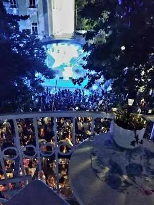 a view of a pool from a balcony at night at Gallery apartment in Podgorica