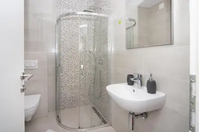 a bathroom with a shower and a sink at City center lux 2bdr apt with garage in Budva