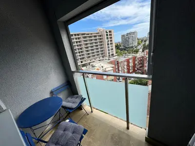 a room with a balcony with a view of a swimming pool at City center lux 2bdr apt with garage in Budva