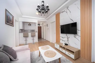 a living room with a couch and a flat screen tv at City center lux 2bdr apt with garage in Budva