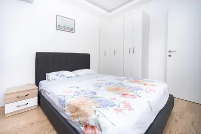 a bedroom with a bed with a floral bedspread at City center lux 2bdr apt with garage in Budva