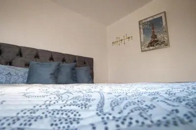 a bedroom with a bed with a blue and white comforter at Villa Sea La vie in Utjeha