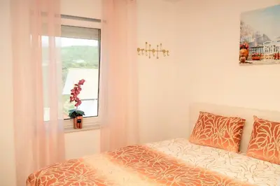 a bedroom with a bed and a window at Villa Sea La vie in Utjeha
