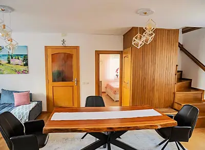 a living room with a dining room table and a bed at Villa Sea La vie in Utjeha
