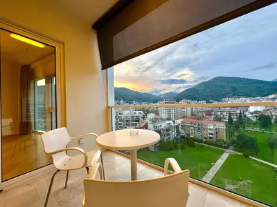 a room with a table and chairs and a large window at The Royal Suite - Tre Canne in Budva