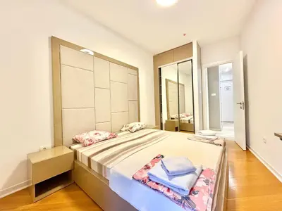 a bedroom with a large bed and a large mirror at The Royal Suite - Tre Canne in Budva