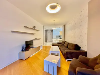 a living room with a couch and a tv at The Royal Suite - Tre Canne in Budva